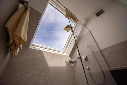a shower with a window in a bathroom at Hotel Drachenwand-Mondsee in Mondsee