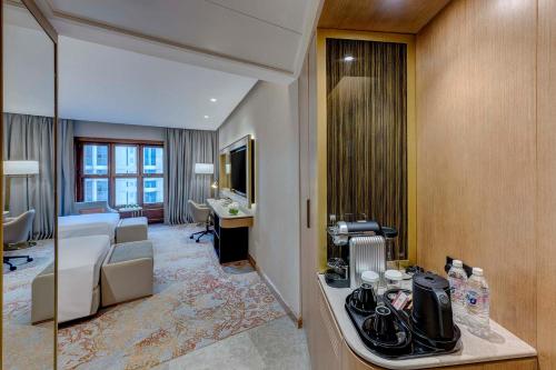 a hotel room with a bed and a desk at Makkah Hotel in Mecca