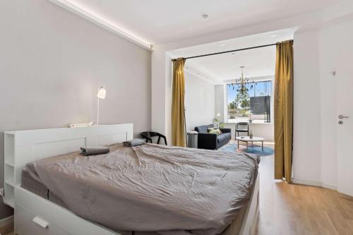 a bedroom with a large bed and a living room at John F Kennedys Suite in Aalborg