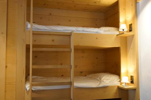 a bunk room with two bunk beds in it at Posthotel Rössli in Gstaad