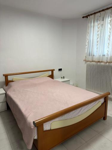 a bedroom with a bed and a window at AirbnbTzo in Perístasis