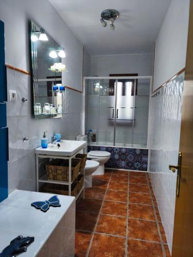 a bathroom with a toilet and a sink and a shower at El Torreón in Valderredible