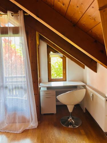 a small kitchen with a desk and a window at Staufen Blick in Piding
