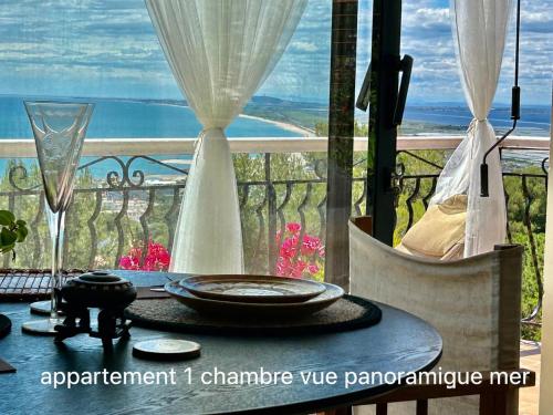 a table with a view of the ocean on a balcony at le lodge Saint Clair in Sète