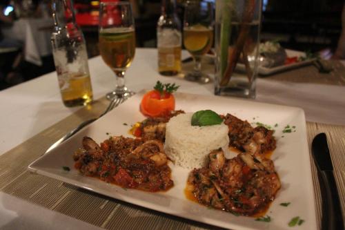 a white plate of food on a table at Villa Côté Sud Pousada De Charme in São Miguel dos Milagres