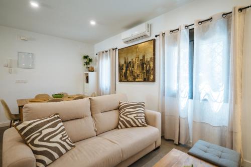 a living room with a couch and a window at Luis Montoto in Seville