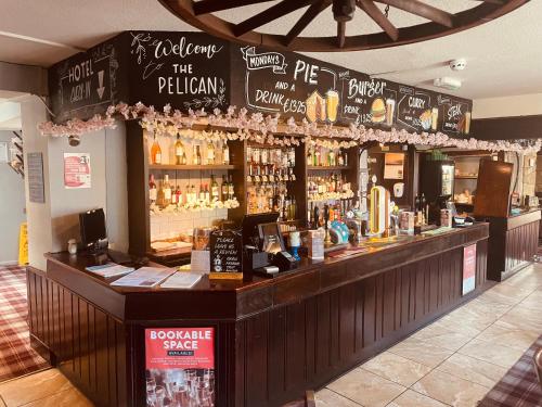 a bar with a lot of bottles of alcohol at The Pelican Inn in Stapleford