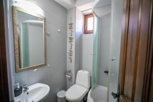 a bathroom with a toilet and a sink and a mirror at Luxury Villa Medusa Temple in Kruševo