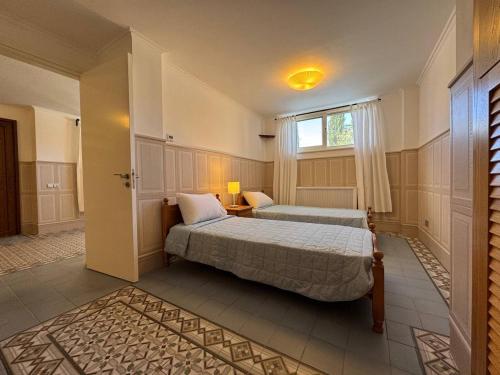 a bedroom with two beds and a window at Beach villa Aurelia in Neo Chorio