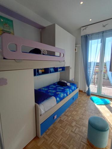 a bedroom with two bunk beds and a large window at A Casa Di Dona in Rimini