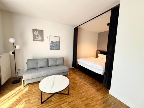 a living room with a couch and a bed at apments - Premium Apartments nahe Hamburg in Rosengarten