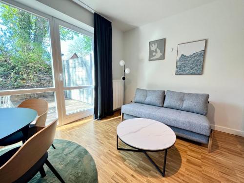 a living room with a couch and a table at apments - Premium Apartments nahe Hamburg in Rosengarten