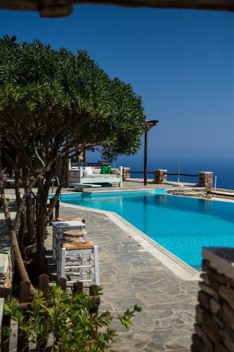 a swimming pool with a view of the ocean at Windmill Bella Vista in Artemonas