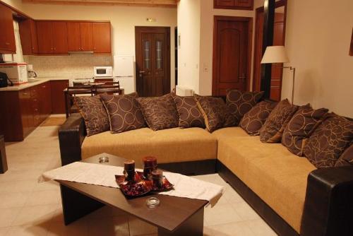 uma sala de estar com um sofá e uma mesa em Oreini Nafpaktia Houses em Palaiópirgos