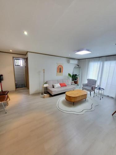 a living room with a couch and a coffee table at 씨하우스 501호 in Hakch'ŏn-dong