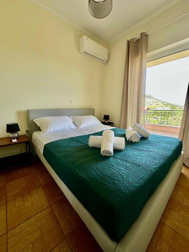 a bedroom with a large bed with towels on it at Elia in Marathon