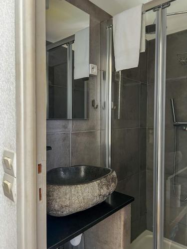 a bathroom with a large stone sink on a counter at Hôtel Castel Saint Anne in Le Castellet