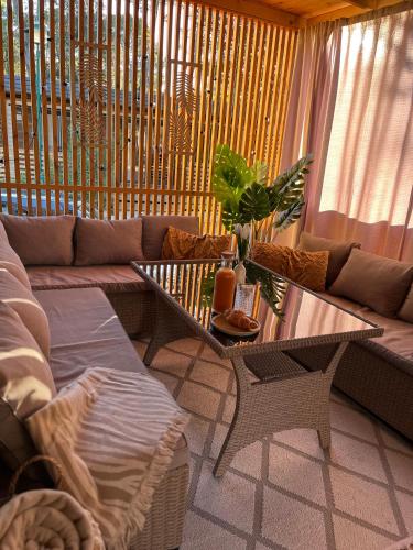 a living room with a couch and a table at Mobile Home Sea Heaven in Biograd na Moru
