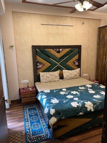 a bedroom with a bed with a painting on the wall at Casa Luxoria in Jalandhar