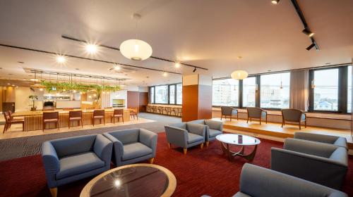 a lobby with chairs and tables and a cafeteria at Quintessa Hotel Akita in Akita
