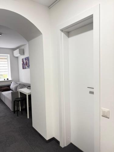 a white room with a door leading into a bedroom at SILVIA apartment 101 in Druskininkai