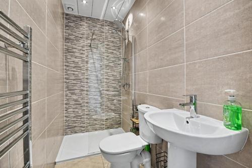 a bathroom with a sink and a toilet and a shower at 173 Newark Street, Greenock in Greenock