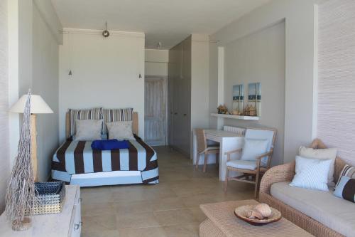 a living room with a bed and a couch at Villa Lefka in Kastrosikia