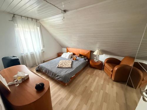 a small bedroom with a bed and a chair at An der Elbaue in Pirna
