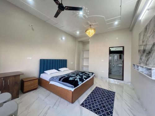 a bedroom with a bed and a ceiling fan at The City View Homestay in Srīnagar