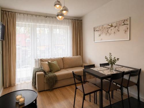 a living room with a couch and a table at Apartamenty Przy Forcie in Kłodzko