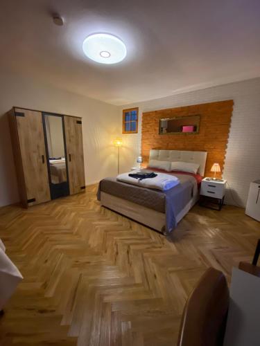 a bedroom with a bed and a wooden floor at EVIA Hotel restaurant in Recklinghausen