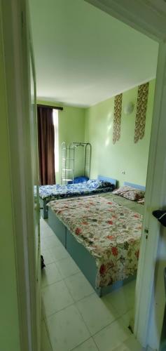 a room with two beds in a room with a doorway at old house ureki in Ureki