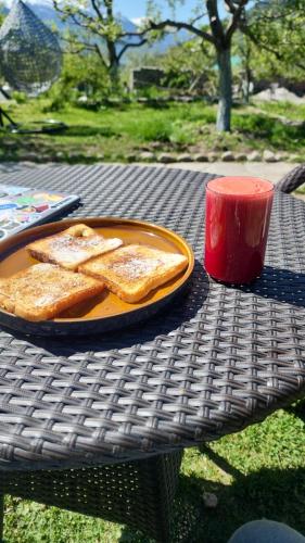 a plate of toast on a table with a red cup at Hotter Potter Stays Manali in Vashisht