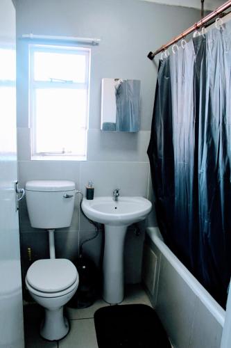 a bathroom with a toilet and a sink at Penthouse in Bloemfontein