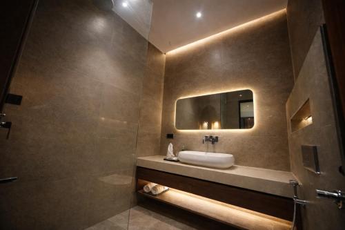 a bathroom with a sink and a mirror at The Cozy Chaos - Spa Jacuzzi -Private Terrace - Taj Mahal in Agra