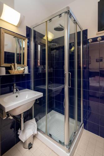 a bathroom with a sink and a shower at Hotel Ancore in Senigallia