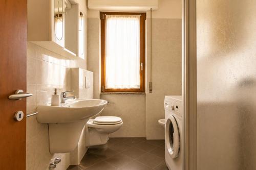 a bathroom with a white toilet and a sink at Apartment Alex 1 in Domaso in Domaso