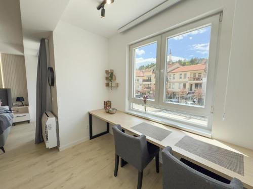 a room with a desk and a large window at The Spot Apartments in Ohrid
