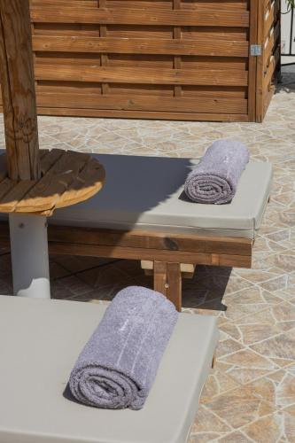 two towels sitting on a table in a room at Cavaliere Seafront House - Klio in Sami