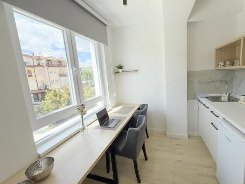 a kitchen with a desk with a laptop on it at The Spot Apartments in Ohrid