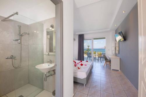 a bathroom with a tub and a sink and a shower at Stella Maris in Kos
