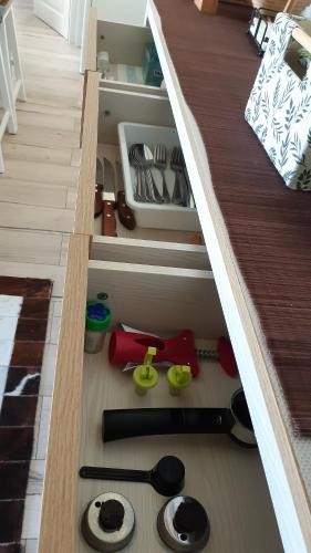 an open kitchen drawer with some utensils in it at Lake & Mountain View Ceahlau in Ceahlău