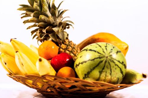 a basket of fruits and vegetables on a table at D'Villa Guest House in Jaffna