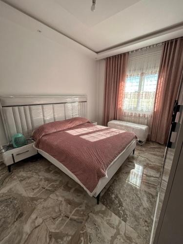 a bedroom with a bed and a window at Casa hersi in Hennchir Ksar Rhaleb