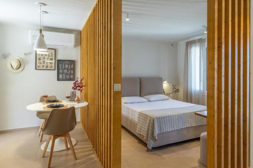 a bedroom with a bed and a table and a desk at Cavaliere Seafront House - Theseus in Sami