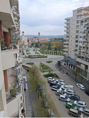 a view of a city with cars parked in a parking lot at COZY PANORAMA Flat in Alba Iulia