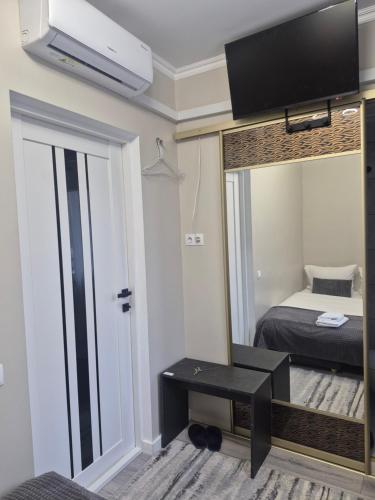 a small room with a bed and a mirror at Budget private room near Northern Bus station in Chişinău
