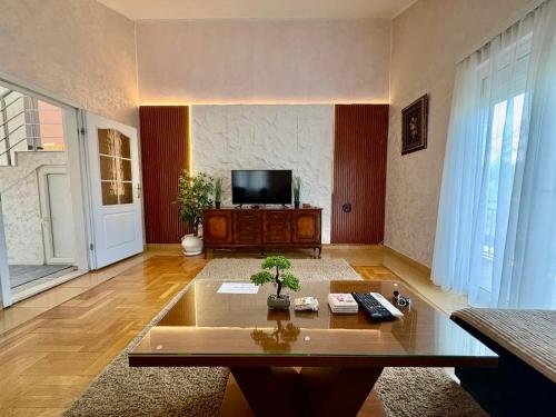a living room with a tv and a coffee table at Blue Escape in Danilovgrad