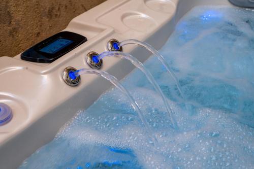 a cell phone in a bath tub with water at La Maison Cabane in Cholet