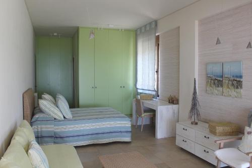 a bedroom with a bed and a desk in it at Villa Lefka in Kastrosikia